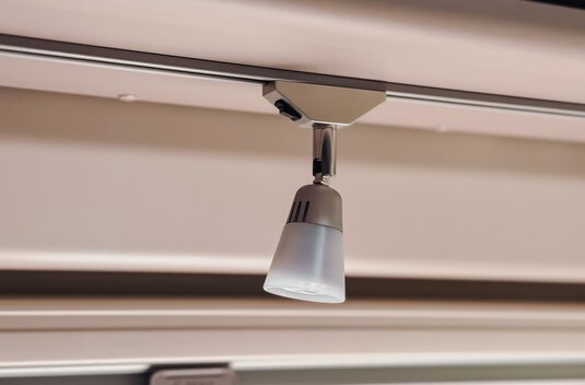 Ceiling spotlight on a track in the interior of a Carado motorhome