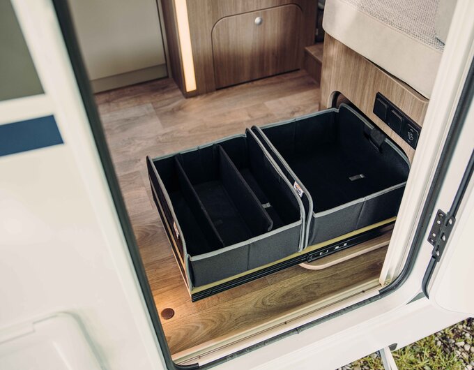 Carado motorhome interior with pull-out storage compartment in the entrance area