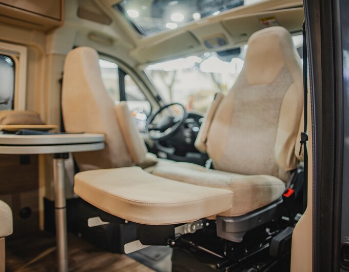 Carado motorhome interior with swivel cab seats and dinette