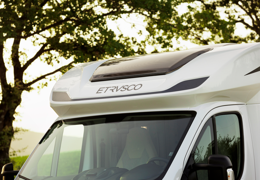 Front of an Etrusco semi-integrated Fiat motorhome with Etrusco logo and panoramic window, ideal for comfort on travels.
