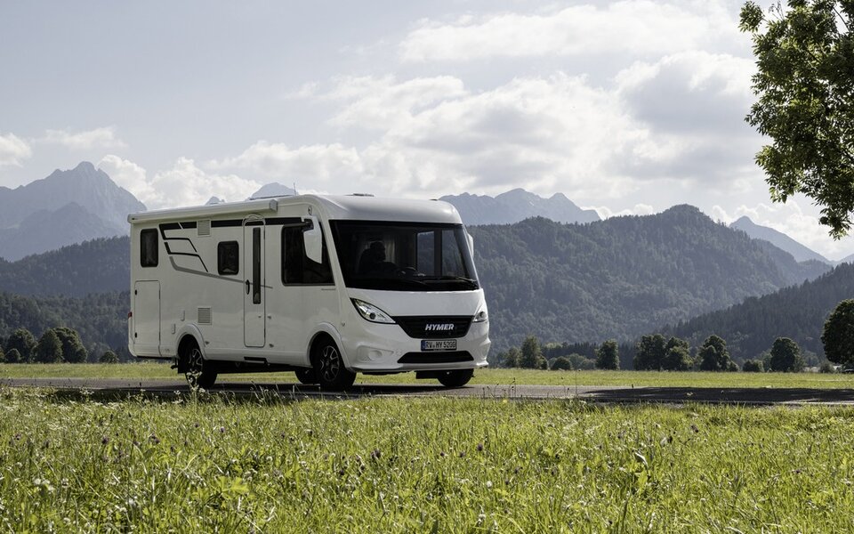 HYMER Exsis-i 580 on the shores of the troubled cold sea and snow-capped mountains